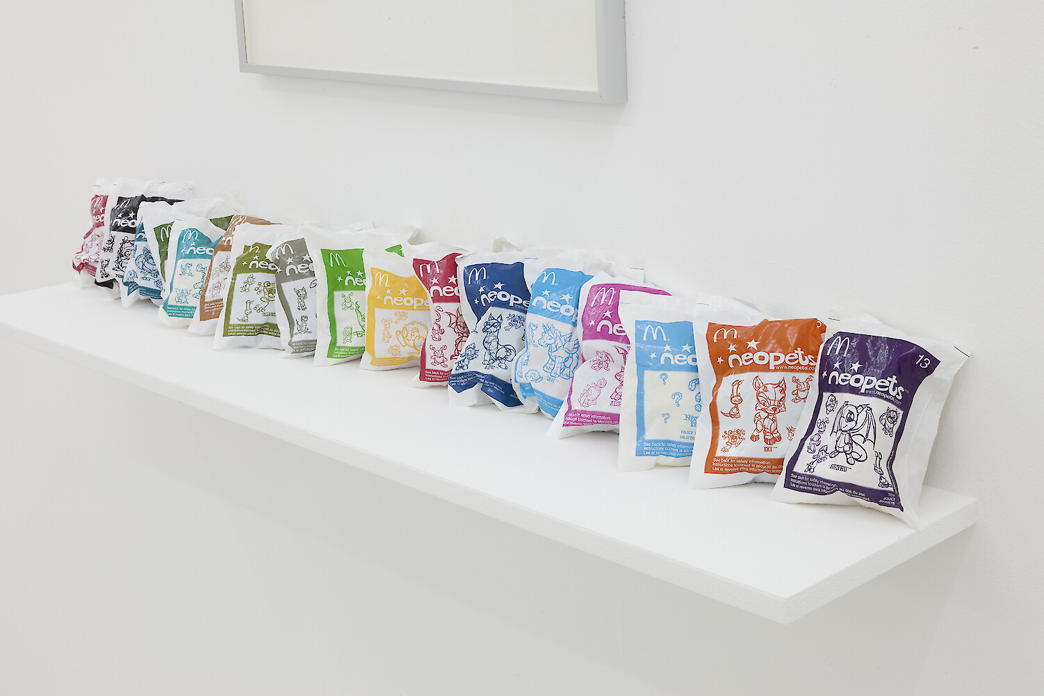 Detail View, *Media Is A Plural Word*, 2018, inkjet on newsprint, McDonald's Happy Meal toys, MDF board, 41.5 x 55 x 2.5 cm