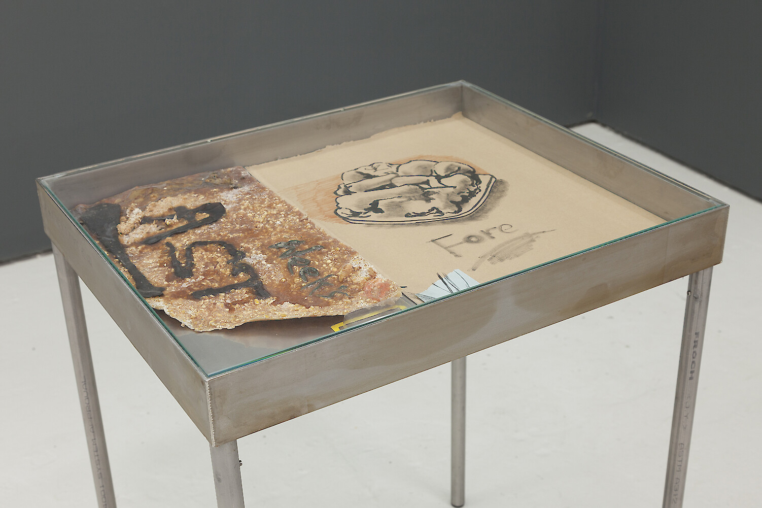 *Fore* (detail view), 2016, Stainless steel vitrine table, Polymer clay, Latex, Couscous, Corn, Plaster, Plastecine, Card, India ink, Marker, Thermal paper, Card, Slate, Steel cut tacs, 25 x 31 cm