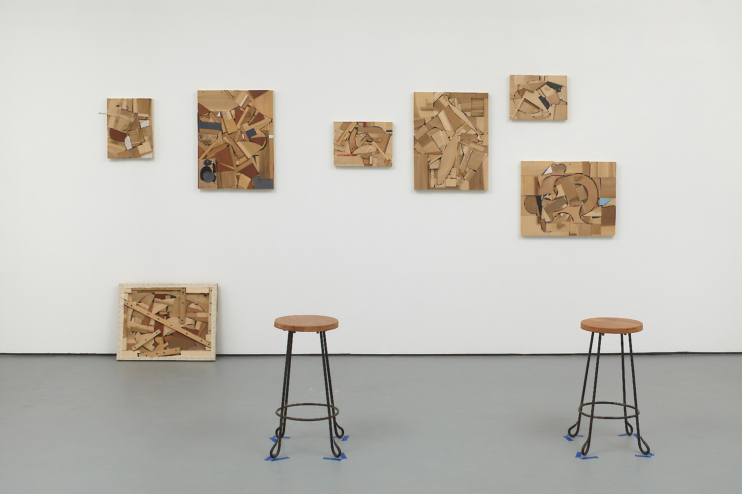 Donelle Woolford, *Studio Scene*, 2009, 7 paintings, 2 stools, dimensions variable